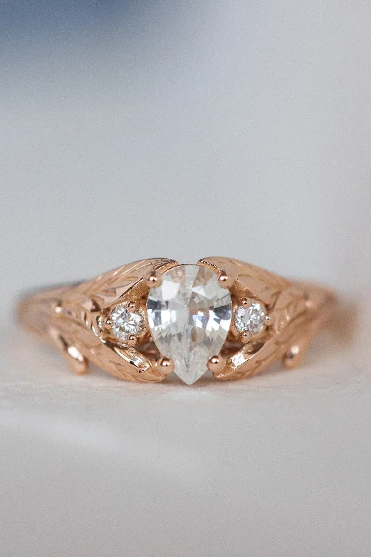 Men's Diamond Engagement Rings with Platinum Band and Halo Setting for a Luxury ProposalREADY TO SHIP: Wisteria ring in 14K rose gold, natural white sapphire pear cut 7x5 mm, accent natural diamonds, AVAILABLE RING SIZES: 5.5 - 8.5 US